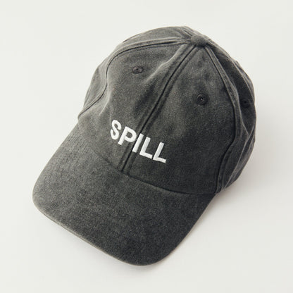 A dark gray washed cotton baseball cap with the word 'SPILL' embroidered in white on the front, photographed on a clean white background.